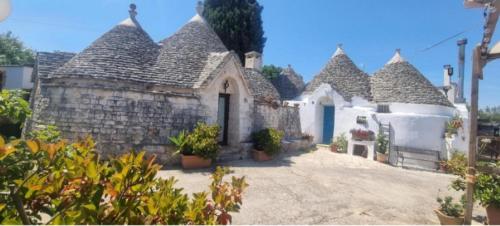 a house with a stone building with a roof at Gasphouse in Castellana Grotte