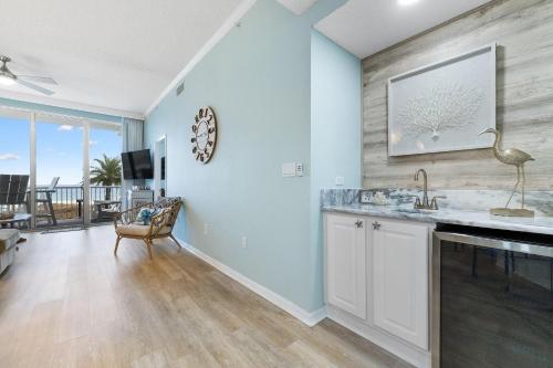 a kitchen with a sink and a living room at Spanish Key 105 in Perdido Key