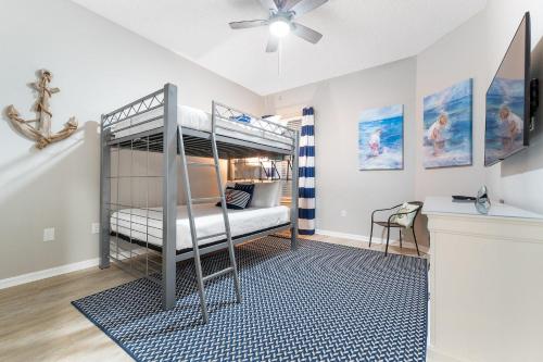 a bedroom with a bunk bed with a ceiling fan at Spanish Key 105 in Perdido Key