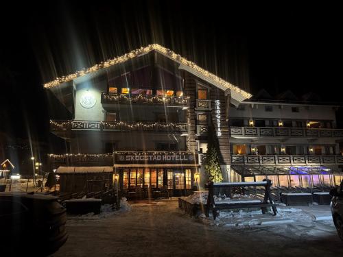 a building with lights on it at night at Skogstad Hotel - Unike Hoteller in Hemsedal