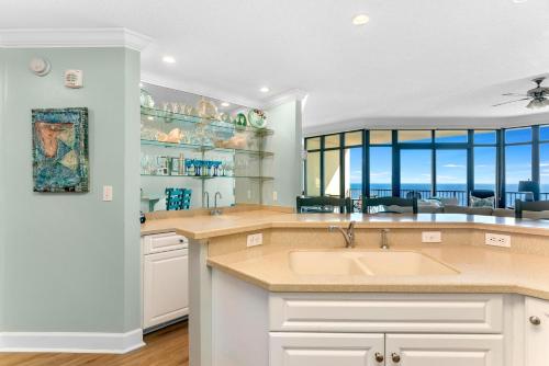 a kitchen with a sink and a view of the ocean at Phoenix West 1508 in Orange Beach