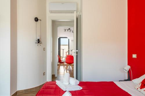 a bedroom with a red bed and a red blanket at Rosso Rubino - Mansarda Vista Lago a Marta in Marta