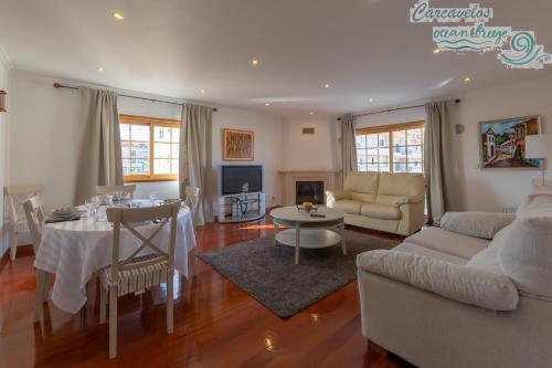 a living room with a couch and a table at Carcavelos Ocean Breeze in Carcavelos