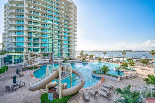 a swimming pool with a water slide in front of a building at Caribe D216 in Orange Beach
