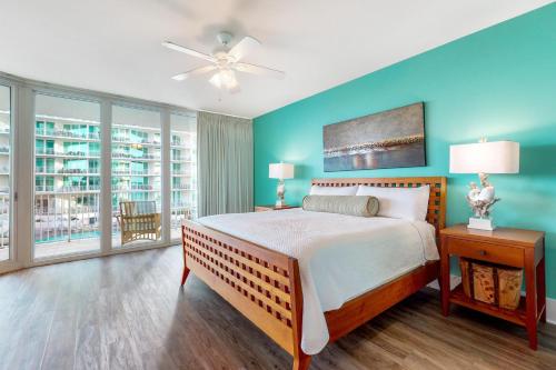 a bedroom with a bed and a ceiling fan at Caribe D216 in Orange Beach