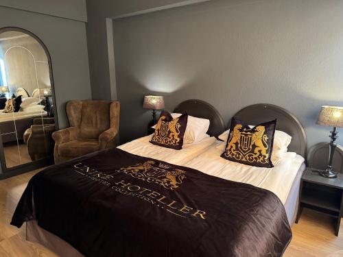 a hotel room with a bed and a chair at Skogstad Hotel - Unike Hoteller in Hemsedal