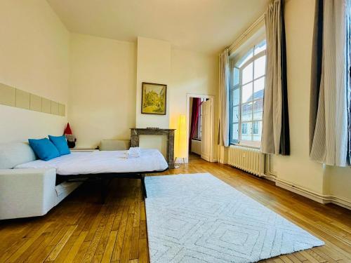 a bedroom with a bed and a large window at Manneken View in Brussels