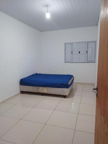 a room with a bed in the corner of a room at Chácara das Colinas in Atibaia