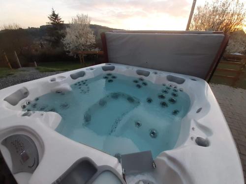 a jacuzzi tub sitting on top of a patio at SrubNemo in Nemotice