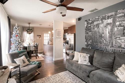 a living room with a couch and a christmas tree at Dog-Friendly Yard! Walkable Dixieland District Gem in Lakeland