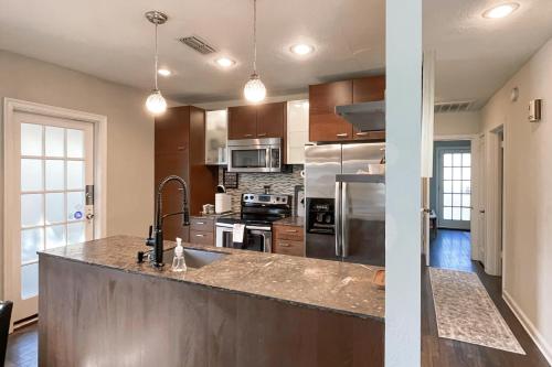 a kitchen with stainless steel appliances and a counter top at Dog-Friendly Yard! Walkable Dixieland District Gem in Lakeland