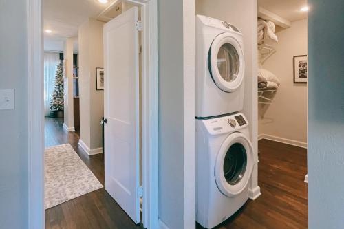 a washer and dryer in a room with a hallway at Dog-Friendly Yard! Walkable Dixieland District Gem in Lakeland