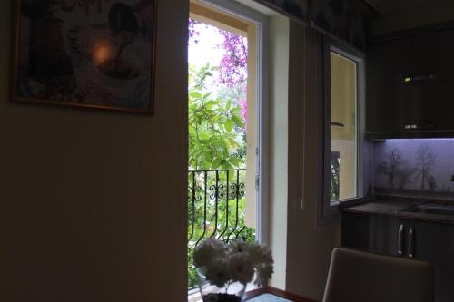 a door leading into a kitchen with a window at Tunacan Hotel in Oludeniz