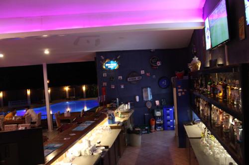 a bar with purple lights in a restaurant at Tunacan Hotel in Oludeniz
