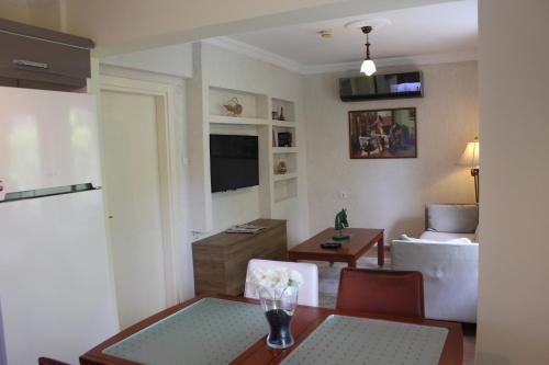 a living room with a table and a dining room at Tunacan Hotel in Oludeniz