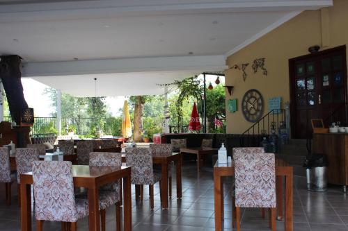a restaurant with tables and chairs in a room at Tunacan Hotel in Oludeniz