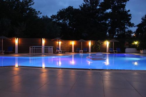 a swimming pool at night with lights on it at Tunacan Hotel in Oludeniz