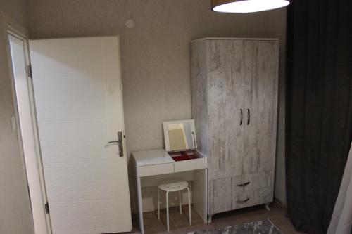 a room with a desk with a computer and a door at Tunacan Hotel in Oludeniz
