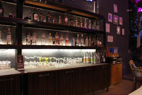 a bar with a lot of bottles of alcohol at Tunacan Hotel in Oludeniz