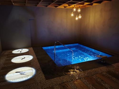 a bathroom with a swimming pool with two sinks and a tub at Hotel Cesa Tyrol in Canazei