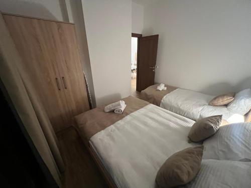 a room with three beds and a closet at Ruža vetrova Zlatar - A2 in Nova Varoš