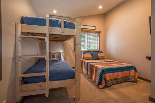 a bedroom with two bunk beds and a bed at 11 Pine Bough - Meredith Lodging in Sunriver