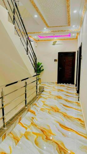 an empty hallway with a painting on the floor at The Lahore Guest House in Lahore