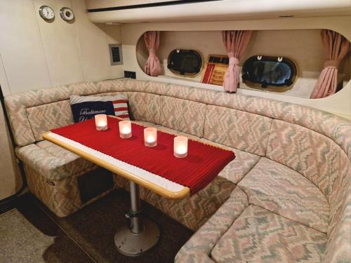 a table in the back of a caravan with candles on it at Prinsessan i Lilla Bommen in Gothenburg