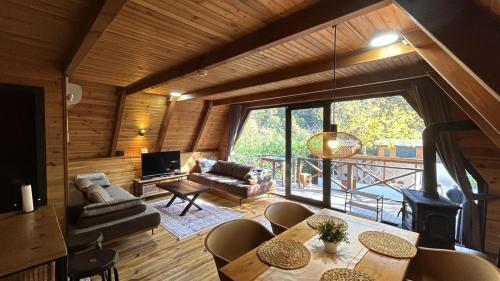 a living room with a couch and a table and chairs at Merce Bungalov in Sapanca