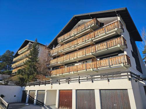 a building with balconies on the side of it at Havre de Paix et Confort à Vercorin, avec vue Panoramique in Vercorin