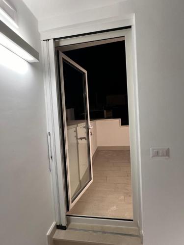 a sliding door with a mirror in a room at San Vito Apartment in Palo del Colle