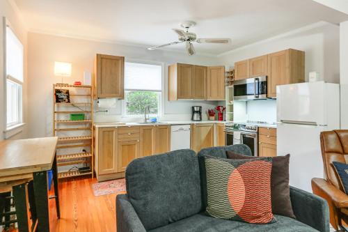 a living room with a couch and a kitchen at Walk Downtown Takoma Park Escape with Large Yard! in Takoma Park