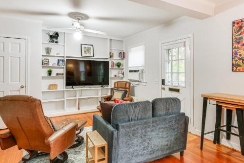 a living room with a couch and chairs and a tv at Walk Downtown Takoma Park Escape with Large Yard! in Takoma Park
