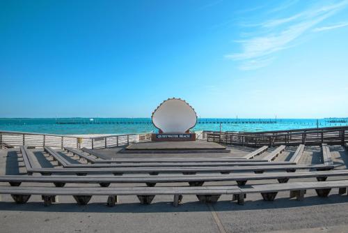 a bench with a shell on it next to the ocean at Santa Rosa Dunes 425 in Pensacola Beach