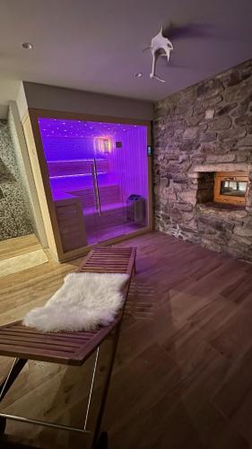 a living room with a stone wall with a purple light at Farma František in Stachy