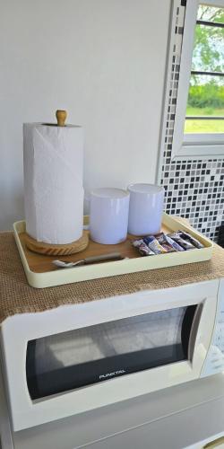 a tray on top of a microwave with two cups at Armonía in Bella Unión