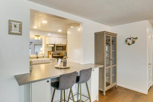 a kitchen with a counter and two bar stools at Family Home with Games and Fenced Yard in South Ogden in South Ogden