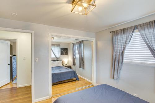 a bedroom with a bed and a hallway with windows at Family Home with Games and Fenced Yard in South Ogden in South Ogden
