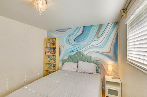 a bedroom with a bed with a painting on the wall at Family Home with Games and Fenced Yard in South Ogden in South Ogden