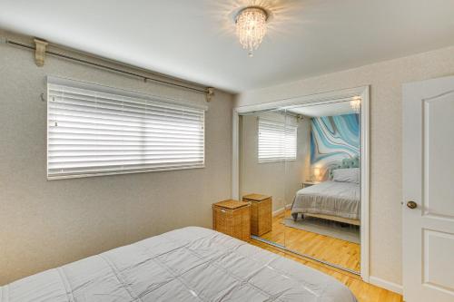 a bedroom with a bed and a window and a mirror at Family Home with Games and Fenced Yard in South Ogden in South Ogden