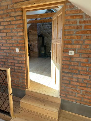a brick wall with a doorway into a room at Chalupy Albrechtice Šumava in Sušice