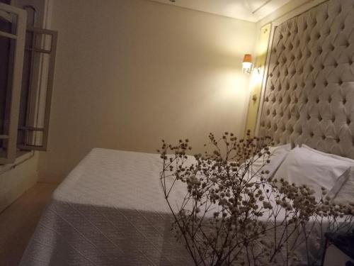 a bedroom with a bed with a white bedspread at CORTESE HOTEL in Tatuí