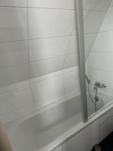 a white bath tub with a faucet in a bathroom at Hotel La Chaumiere in Asse