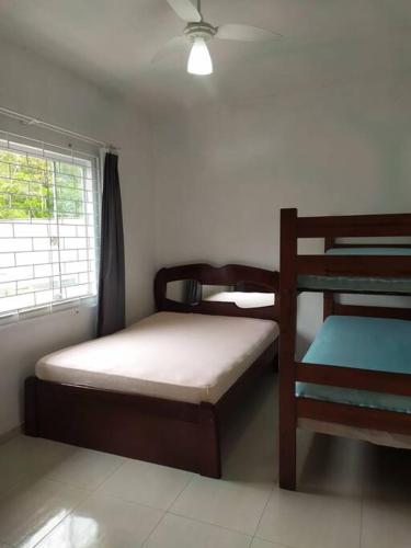 a bedroom with two bunk beds and a window at Casa com Piscina e ampla area de festas in Barra Velha