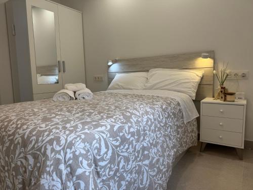 a bedroom with a large bed and a mirror at Cabosun in El Cabo de Gata