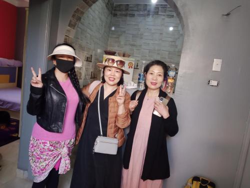 three women in costumes posing for a picture at Fekry home in Aswan