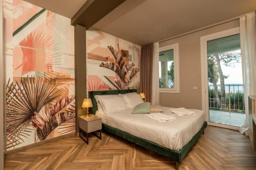 a bedroom with a bed with a painting on the wall at Bed & Breakfast LA HOME and Apartments in Moniga