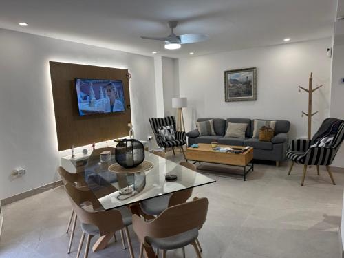 a living room with a table and chairs and a couch at Cabosun in El Cabo de Gata