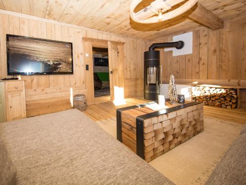 a living room with a stove and a tv at Das Wiesegg in Fügenberg
