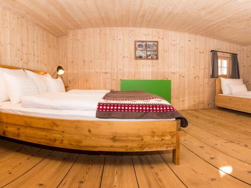 a bedroom with a bed in a wooden room at Das Wiesegg in Fügenberg